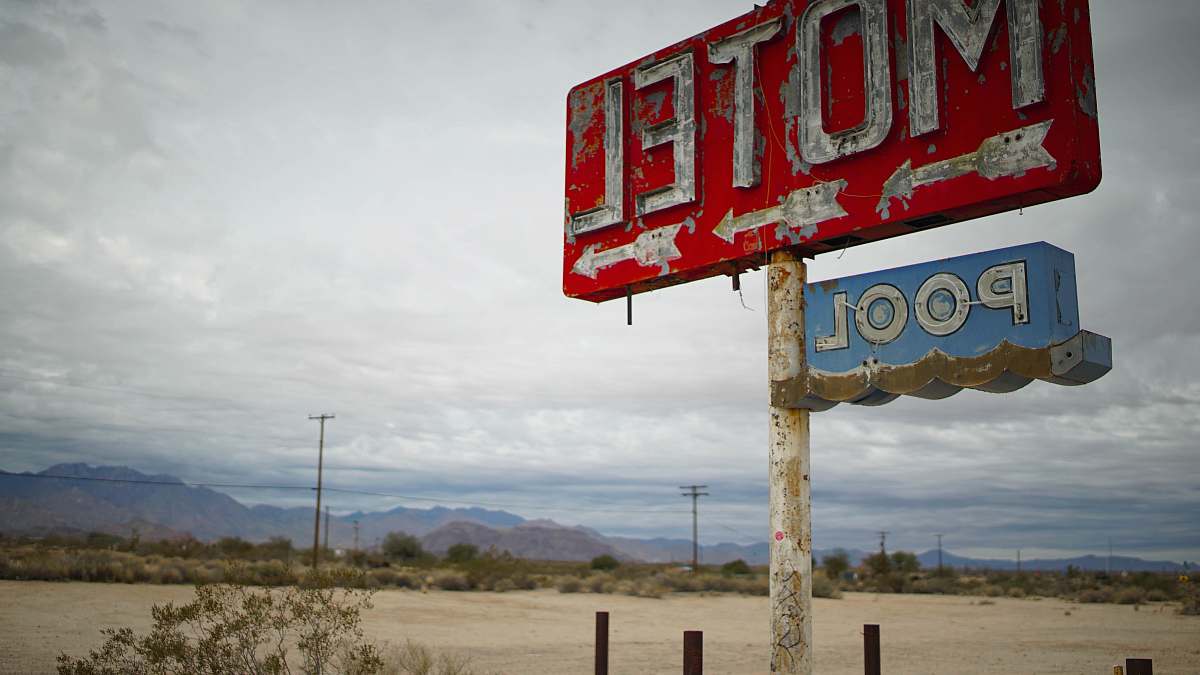 amargosa valley red motel signage in shallow focus clouds